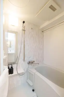 a white bathroom with a tub and a shower at Hotel ONE in Tokyo