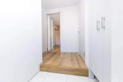 an empty hallway with white walls and wood floors at 5 min walk to station, New building, 15 m Meguro River in Tokyo