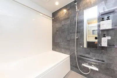 a bathroom with a shower and a bath tub at 5 min walk to station, New building, 15 m Meguro River in Tokyo