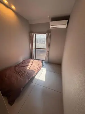 a small bedroom with a bed and a window at BEDandBAR MIDUKI \u30db\u30b9\u30c6\u30eb in Tokyo