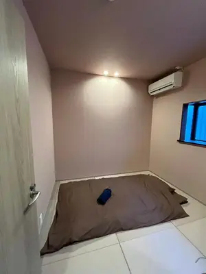 a small room with a bed next to a window at BEDandBAR MIDUKI \u30db\u30b9\u30c6\u30eb in Tokyo