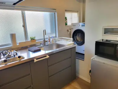 a kitchen with a sink and a microwave at DUPLEX TINY Apartments, 1 Listing Central Near Shinjuku in Tokyo