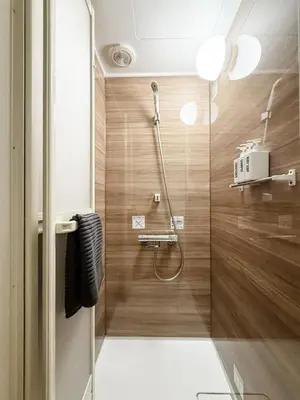a bathroom with a shower with wooden walls at DUPLEX TINY Apartments, 1 Listing Central Near Shinjuku in Tokyo