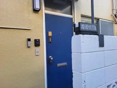 a blue door on the side of a building at DUPLEX TINY Apartments, 1 Listing Central Near Shinjuku in Tokyo