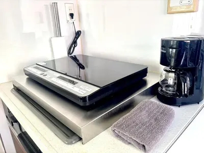 a laptop sitting on top of a kitchen counter at 2F Spacious Apartment in Shinjuku, Shibuya Tokyo in Tokyo