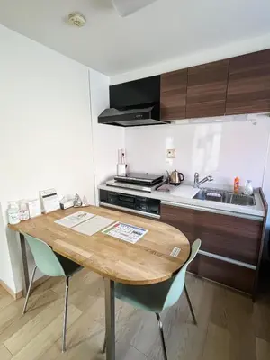 a kitchen with a wooden table and two chairs at 2F Spacious Apartment in Shinjuku, Shibuya Tokyo in Tokyo