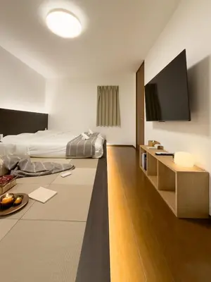 a bedroom with a bed and a flat screen tv at ISSHUKU NOMA\u6c60\u888bII 201 - Spacious Room for 5 Guests in Tokyo