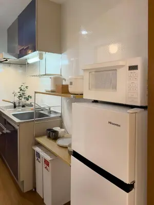 a kitchen with a microwave on top of a refrigerator at ISSHUKU NOMA\u6c60\u888bII 201 - Spacious Room for 5 Guests in Tokyo