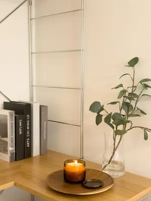 a candle on a table with a vase with a plant at ISSHUKU NOMA\u6c60\u888bII 203 - Quad Room in Tokyo