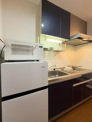 a kitchen with a white refrigerator and a sink at ISSHUKU NOMA\u6c60\u888bII 205 - Quad Room in Tokyo