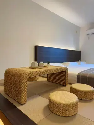a bedroom with a bed and a table and chairs at ISSHUKU NOMA\u6c60\u888bII 205 - Quad Room in Tokyo