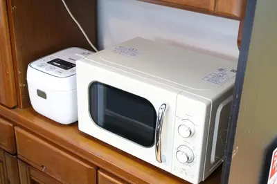a microwave sitting on a counter next to a toaster at Urban Hills IKEBUKURO 51sqm Big 1LDK 5people Beautiful Japanese Interior in Tokyo