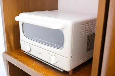 a white microwave sitting on top of a shelf at Urban Hills IKEBUKURO 51sqm Big 1LDK 5people Beautiful Japanese Interior in Tokyo