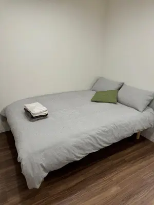 a bed with two pillows and a blanket at C&H hotel2F in Tokyo