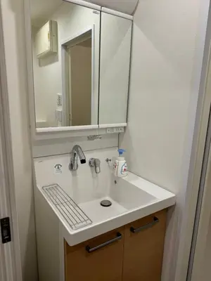 a bathroom with a sink and a mirror at C&H hotel2F in Tokyo