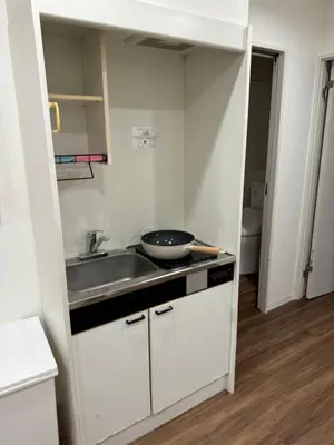 a kitchen with a sink and a bowl on the counter at C&H hotel2F in Tokyo