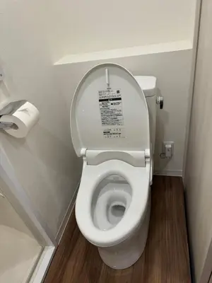 a toilet with the lid up in a bathroom at C&H hotel2F in Tokyo