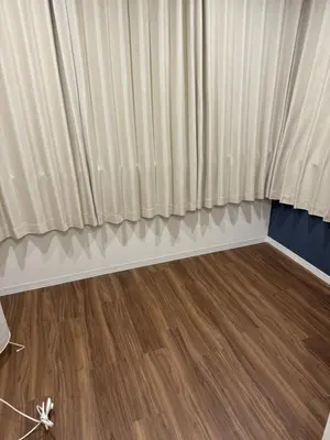 a room with a curtain and a wooden floor at C&H hotel1F in Tokyo