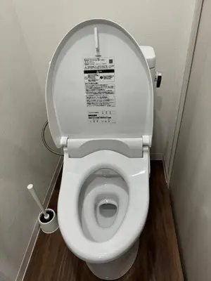 a white toilet with the lid up in a bathroom at C&H hotel1F in Tokyo