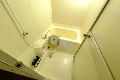 a small white bathroom with a sink in it at F-City \u4e2d\u845b\u897f I in Tokyo