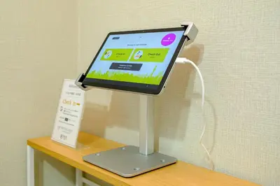 a tablet computer on a stand on a table at F-City \u4e2d\u845b\u897f I in Tokyo