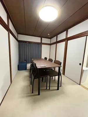 a dining room with a wooden table and chairs at Koenji house in Tokyo