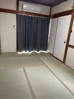 an empty room with a window and a curtain at Koenji house in Tokyo