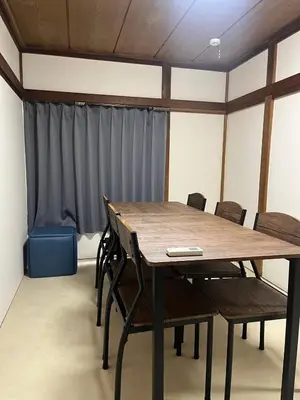 a conference room with a wooden table and chairs at Koenji house in Tokyo
