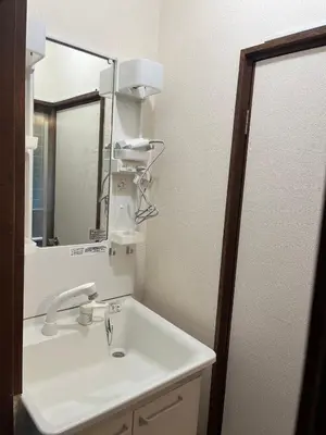 a bathroom with a white sink and a mirror at Koenji house in Tokyo