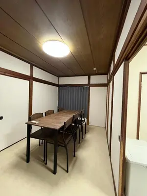 a conference room with a wooden table and chairs at Koenji house in Tokyo