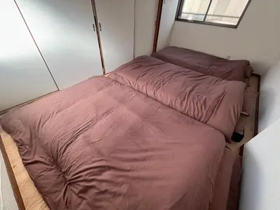 a small bedroom with two beds in it at Koenji house in Tokyo