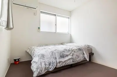 a bedroom with a bed and a window at Haneda Hub 7km to HND- 6min Walk to Omori Stn in Tokyo