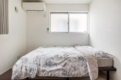 a bedroom with a bed and a window at Haneda Hub 7km to HND- 6min Walk to Omori Stn in Tokyo