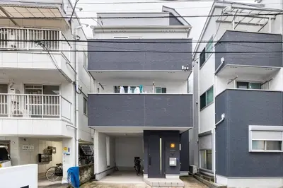 an apartment building with a black door in the middle at Haneda Hub 7km to HND- 6min Walk to Omori Stn in Tokyo