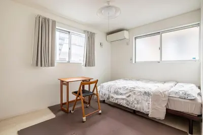 a bedroom with a bed and a desk and window at Haneda Hub 7km to HND- 6min Walk to Omori Stn in Tokyo