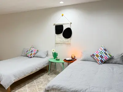 a living room with two beds and a table at C&H 5丁目B1ｆ in Tokyo