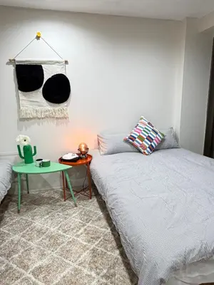 a bedroom with a bed and a green table at C&H 5丁目B1ｆ in Tokyo