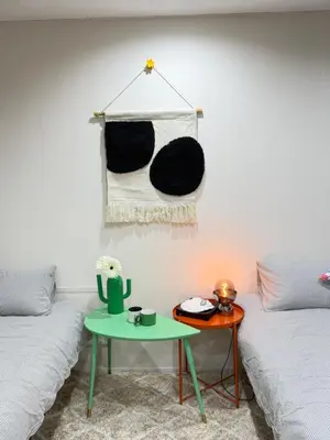 a living room with two beds and a table at C&H 5丁目B1ｆ in Tokyo