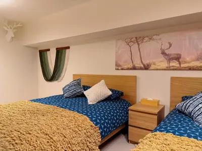 a bedroom with two beds and a picture of a deer at TokyoShinjuk Station800meterskabukicho2minutes101 in Tokyo