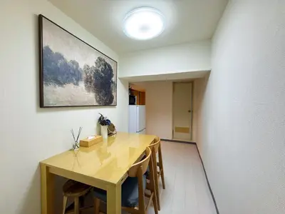 a dining room with a table and a refrigerator at TokyoShinjuk Station800meterskabukicho2minutes101 in Tokyo