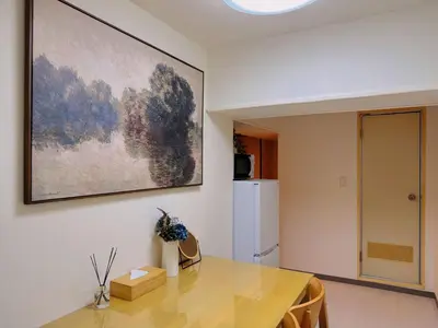 a dining room with a table and a painting on the wall at TokyoShinjuk Station800meterskabukicho2minutes101 in Tokyo