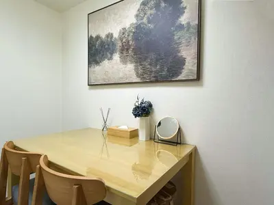 a dining room table with a picture on the wall at TokyoShinjuk Station800meterskabukicho2minutes101 in Tokyo