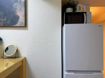a white refrigerator with a microwave on top of it at TokyoShinjuk Station800meterskabukicho2minutes101 in Tokyo