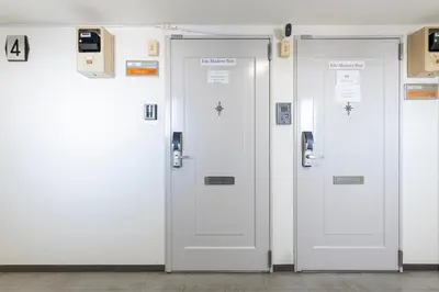 a row of white doors in a building at \u30a8\u30c9\u30e2\u30c0\u30f3\u30b9\u30c6\u30a4 Edo Modern Stay 02 in Tokyo