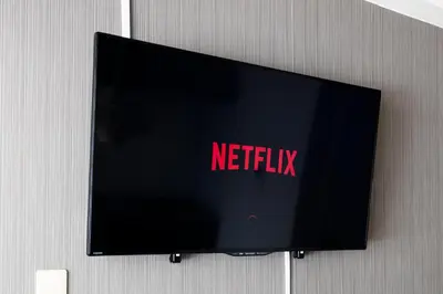 a television on a wall with the netflix sign on it at \u30a8\u30c9\u30e2\u30c0\u30f3\u30b9\u30c6\u30a4 Edo Modern Stay 02 in Tokyo