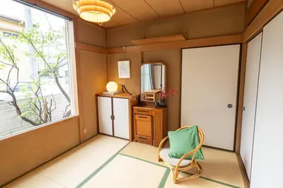 a room with a chair and a window at Japanese life with garden, 2BR, feel & enjoy seasons in Tokyo