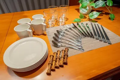 a table with plates and utensils on a table at Japanese life with garden, 2BR, feel & enjoy seasons in Tokyo