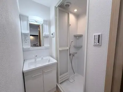 a white bathroom with a sink and a shower at \u5e83\u6587\u6771\u6c60\u888b302 in Tokyo