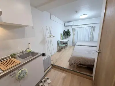 a small kitchen with a bed and a sink in a room at \u5e83\u6587\u6771\u6c60\u888b302 in Tokyo