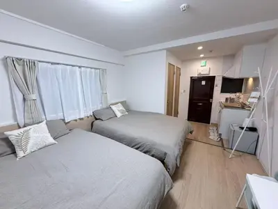 a hotel room with two beds and a kitchen at \u5e83\u6587\u6771\u6c60\u888b302 in Tokyo